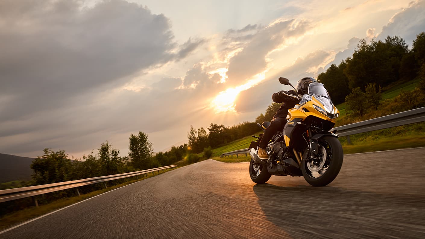 Triumph Tiger Sport 800 riding shot with sun in the background
