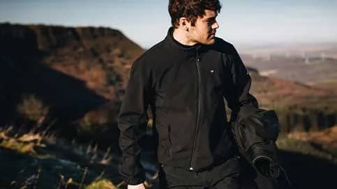 A man wearing a black Triumph motorcycle base layer